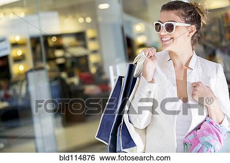 Stock Photograph - Caucasian woman shopping in mall. Fotosearch