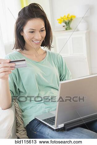 Stock Image - Caucasian woman shopping online. Fotosearch