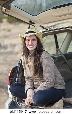 Caucasian woman smiling in hatchback of car View Large Photo Image Stock Photo - Caucasian woman smiling in hatchback of car. Fotosearch