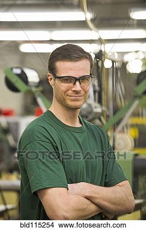Picture - Caucasian worker smiling in textile factory. Fotosearch