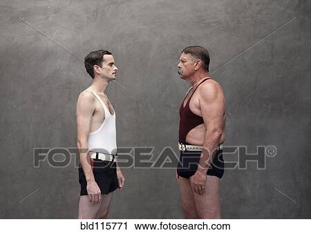 Stock Image - Caucasian wrestlers examining each other. Fotosearch