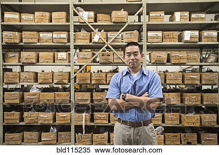 Stock Photography - Chinese worker smiling in textile factory. Fotosearch
