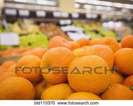 Stock Image - Close up of fruit for sale in grocery store. Fotosearch