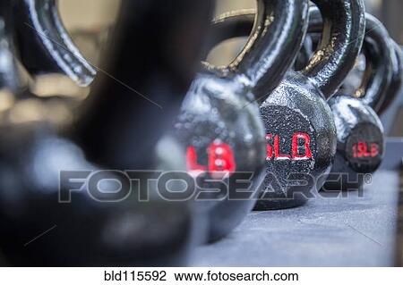 Stock Image - Close up of weights in gym. Fotosearch