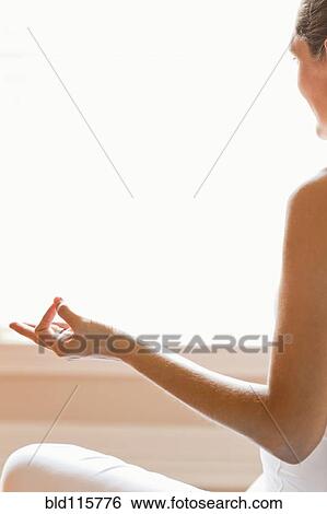 Stock Photograph - Close up of woman meditating. Fotosearch