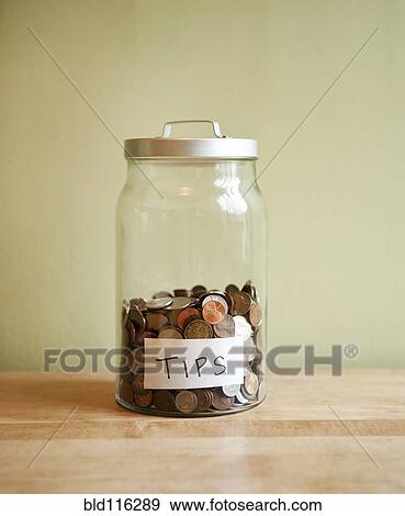 Stock Photo - Coins in tip jar. Fotosearch