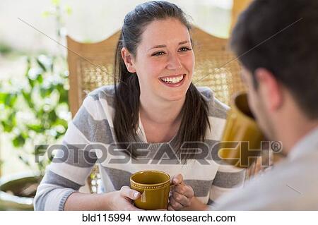 Couple having cup of coffee on patio View Large Photo Image Picture - Couple having cup of coffee on patio. Fotosearch