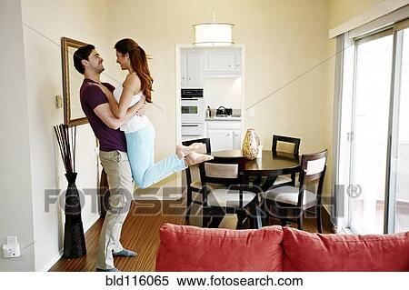 Couple hugging in dining room View Large Photo Image Stock Photography - Couple hugging in dining room. Fotosearch