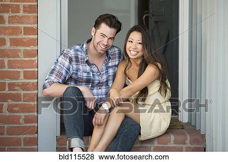 Couple smiling together in doorway View Large Photo Image Stock Photo - Couple smiling together in doorway. Fotosearch