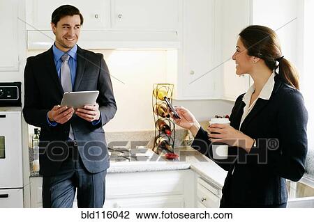 Couple talking in kitchen View Large Photo Image Stock Image - Couple talking in kitchen. Fotosearch