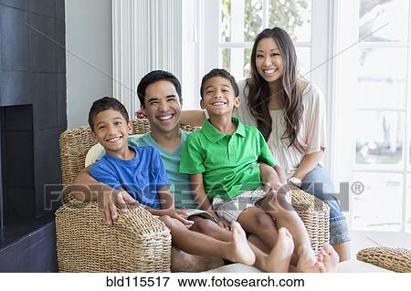 Stock Photo - Family posing together in living room. Fotosearch