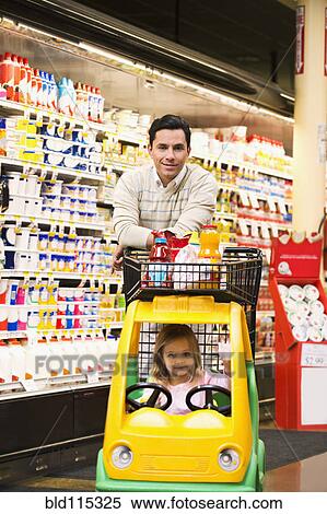 Stock Photography - Father and daughter shopping in grocery store. Fotosearch