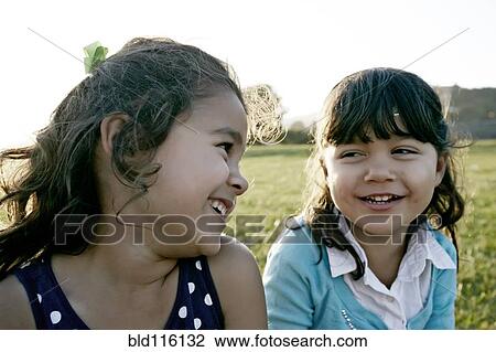 Girls playing in field View Large Photo Image Stock Image - Girls playing in field. Fotosearch