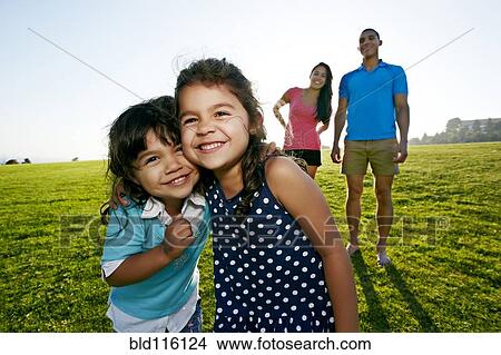 Girls smiling together in field View Large Photo Image Picture - Girls smiling together in field. Fotosearch