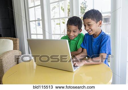 Hispanic boys using laptop View Large Photo Image Stock Image - Hispanic boys using laptop. Fotosearch