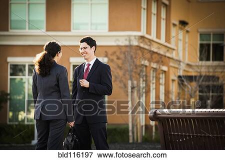 Hispanic business people talking outdoors View Large Photo Image Stock Photo - Hispanic business people talking outdoors. Fotosearch