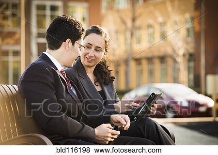 Hispanic business people using tablet computer View Large Photo Image Stock Photo - Hispanic business people using tablet computer. Fotosearch