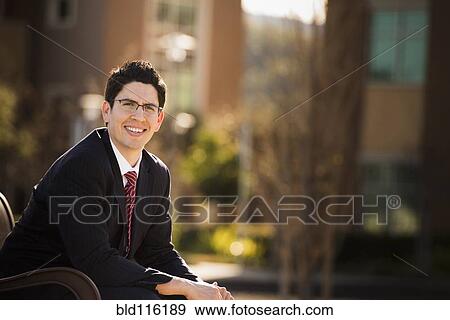 Hispanic businessman sitting outdoors View Large Photo Image Stock Photo - Hispanic businessman sitting outdoors. Fotosearch