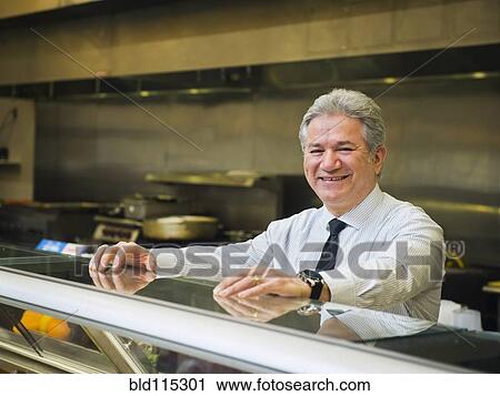 Hispanic businessman smiling in kitchen View Large Photo Image Stock Image - Hispanic businessman smiling in kitchen. Fotosearch