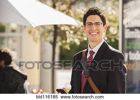 Hispanic businessman smiling outdoors View Large Photo Image Stock Photography - Hispanic businessman smiling outdoors. Fotosearch