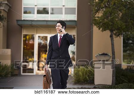 Stock Photo - Hispanic businessman talking on cell phone. Fotosearch