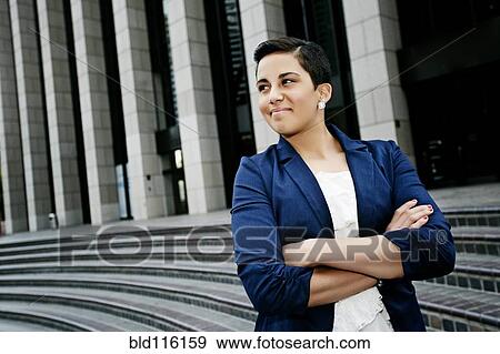 Stock Photo - Hispanic businesswoman standing on steps. Fotosearch