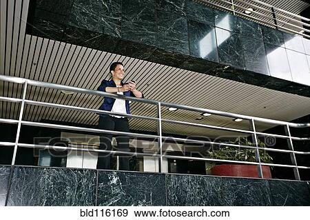 Stock Photo - Hispanic businesswoman using cell phone. Fotosearch