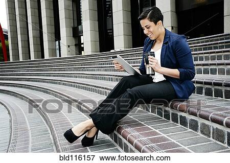 Stock Photo - Hispanic businesswoman using tablet computer. Fotosearch