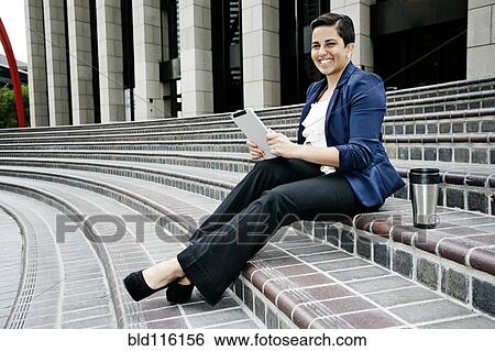 Stock Photograph - Hispanic businesswoman using tablet computer. Fotosearch