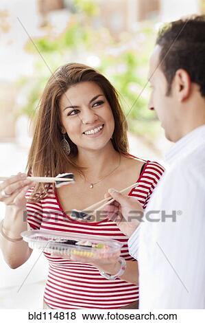 Hispanic couple eating sushi together View Large Photo Image Stock Photo - Hispanic couple eating sushi together. Fotosearch