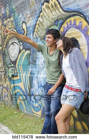 Stock Photo - Hispanic couple relaxing outdoors. Fotosearch
