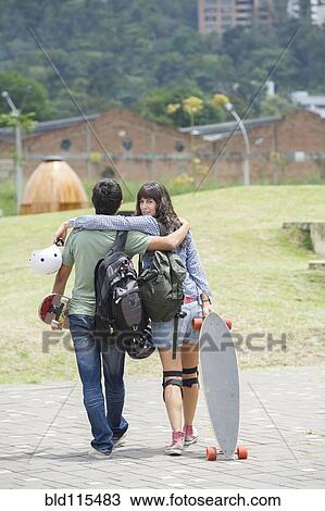 Hispanic couple walking outdoors View Large Photo Image Stock Image - Hispanic couple walking outdoors. Fotosearch