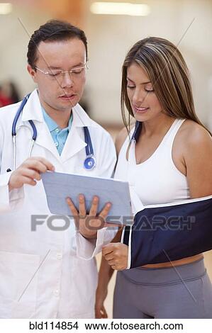Hispanic doctor and patient using tablet computer View Large Photo Image Picture - Hispanic doctor and patient using tablet computer. Fotosearch