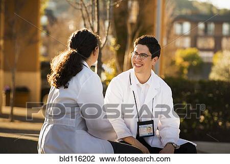 Hispanic doctors talking outdoors View Large Photo Image Stock Image - Hispanic doctors talking outdoors. Fotosearch