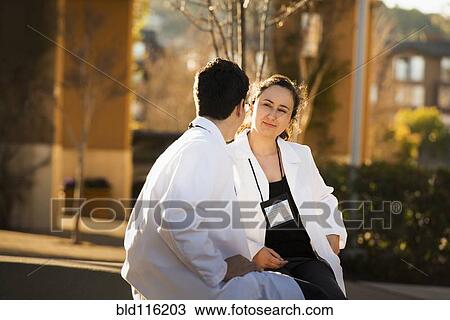Hispanic doctors talking outdoors View Large Photo Image Stock Image - Hispanic doctors talking outdoors. Fotosearch