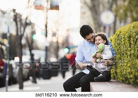 Hispanic father and daughter laughing on city street View Large Photo Image Stock Image - Hispanic father and daughter laughing on city street. Fotosearch