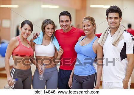 Stock Photograph - Hispanic friends smiling in gym. Fotosearch