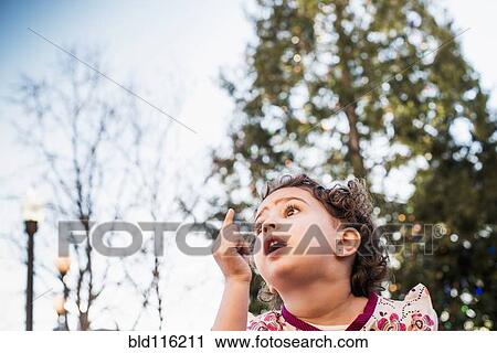 Hispanic girl gasping outdoors View Large Photo Image Stock Image - Hispanic girl gasping outdoors. Fotosearch