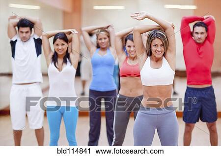 Hispanic people taking exercise class in gym View Large Photo Image Stock Image - Hispanic people taking exercise class in gym. Fotosearch