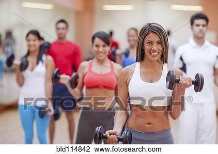 Hispanic people taking exercise class in gym View Large Photo Image Stock Image - Hispanic people taking exercise class in gym. Fotosearch