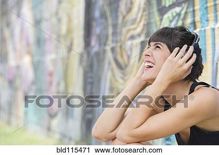 Hispanic woman listening to headphones View Large Photo Image Stock Image - Hispanic woman listening to headphones. Fotosearch