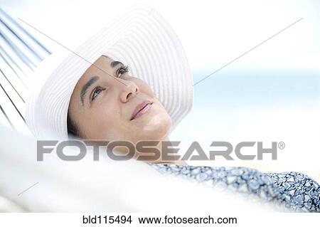 Picture - Hispanic woman relaxing in hammock. Fotosearch