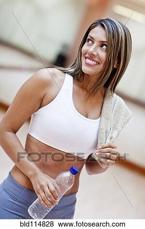 Hispanic woman smiling in gym View Large Photo Image Stock Photo - Hispanic woman smiling in gym. Fotosearch