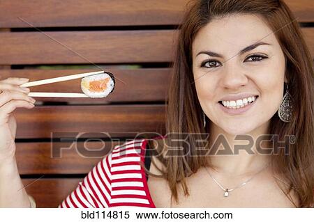 Hispanic woman smiling with sushi View Large Photo Image Stock Photography - Hispanic woman smiling with sushi. Fotosearch