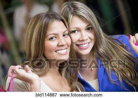 Stock Photo - Hispanic women shopping together. Fotosearch