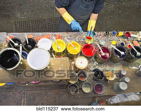 Hispanic worker mixing paint in workshop View Large Photo Image Stock Photo - Hispanic worker mixing paint in workshop. Fotosearch