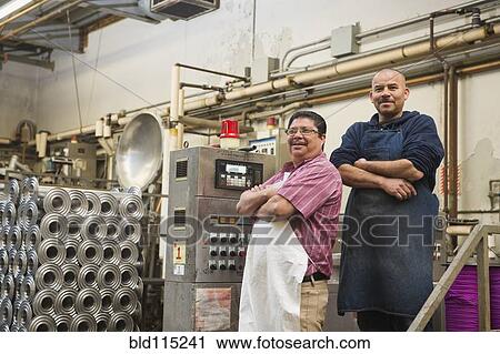 Hispanic workers smiling in textile factory View Large Photo Image Stock Image - Hispanic workers smiling in textile factory. Fotosearch