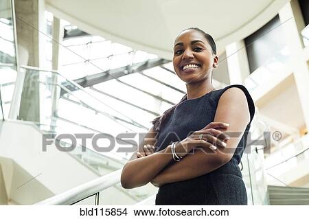 Picture - Indian businesswoman smiling in office. Fotosearch