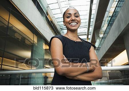 Indian businesswoman smiling in office View Large Photo Image Stock Image - Indian businesswoman smiling in office. Fotosearch