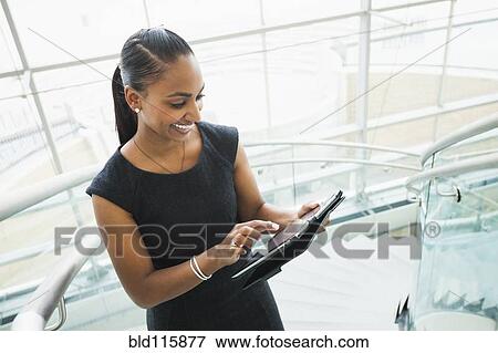 Stock Photo - Indian businesswoman using digital tablet. Fotosearch
